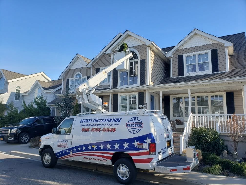 Our wrapped van in front of a two-story house with the bucket raised to the roofline